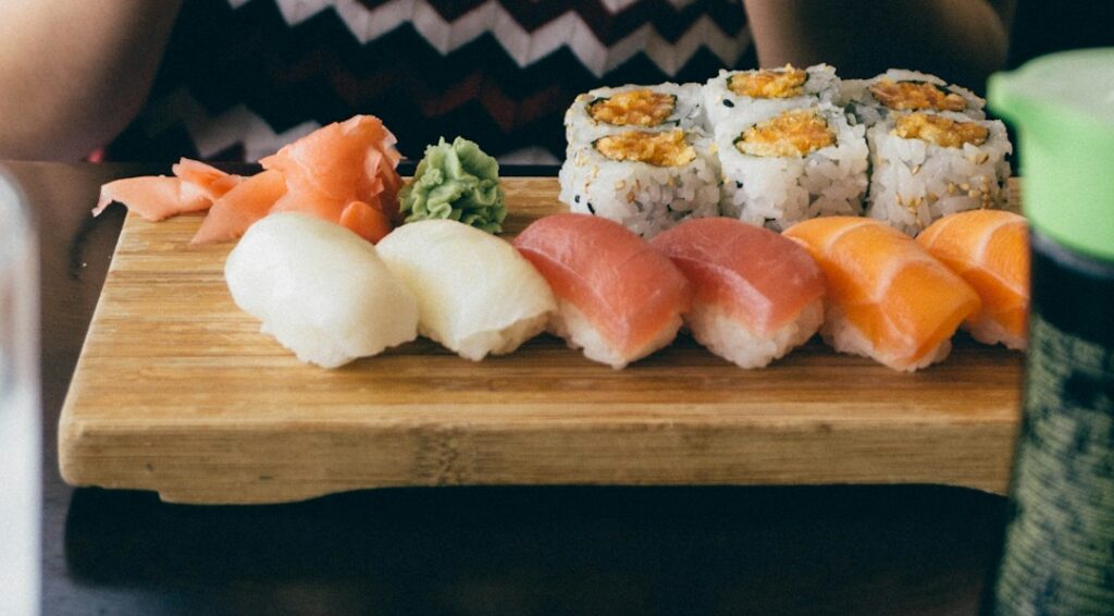 person sitting in front of sushi dish on table