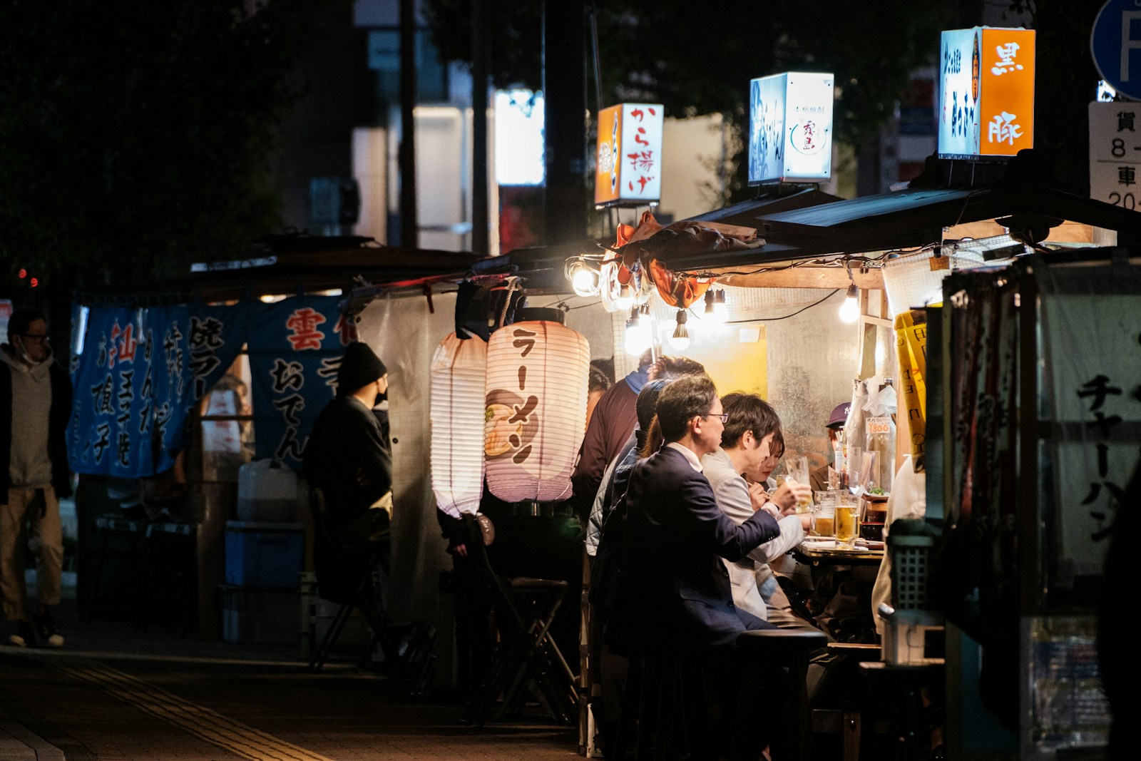 a group of people sitting at a table in front of a store