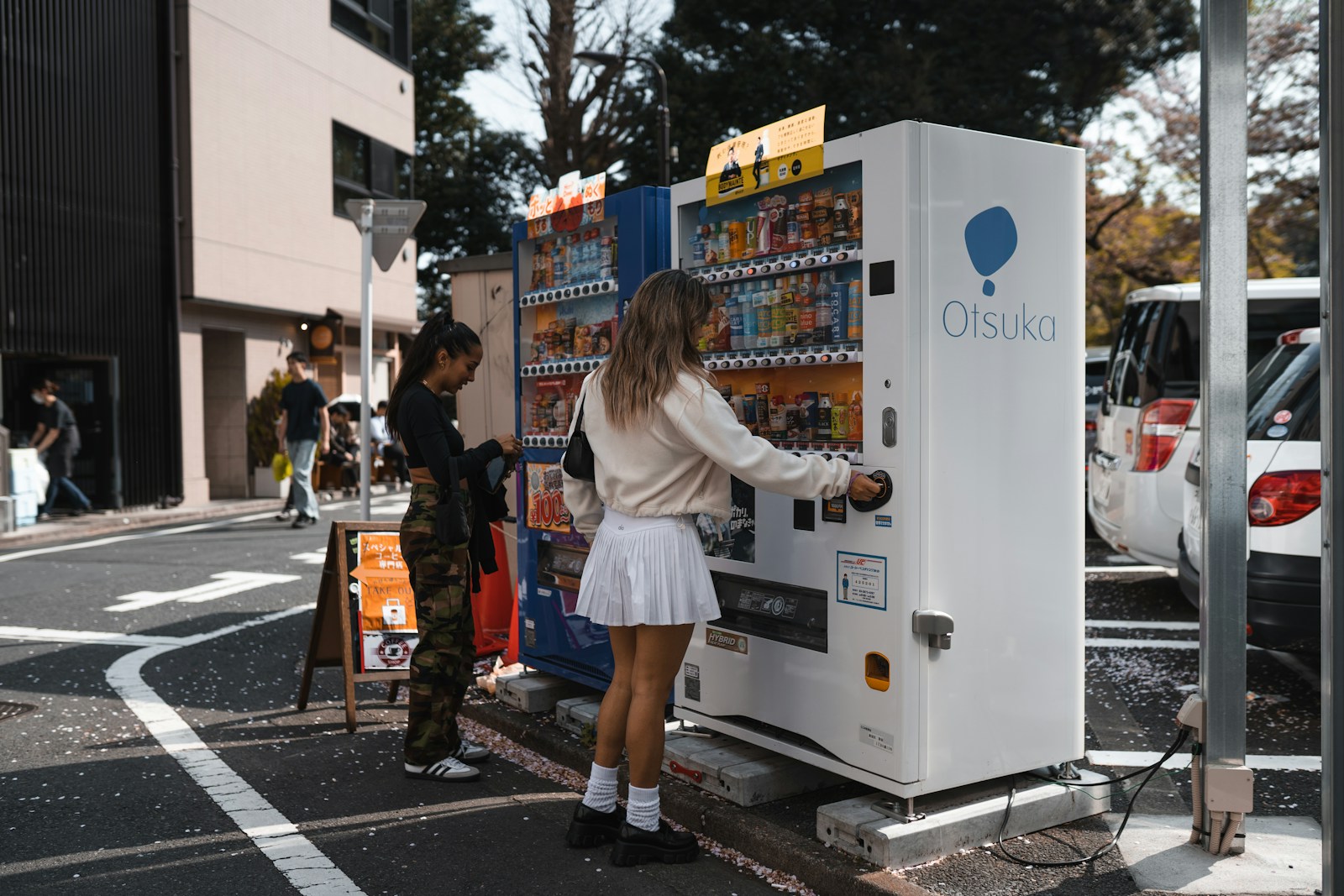 a woman standing next to a vending machine