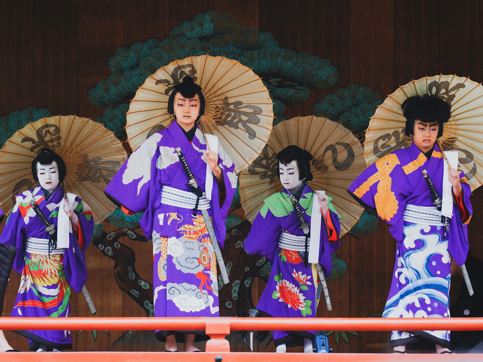 woman in kimono standing on wooden bridge