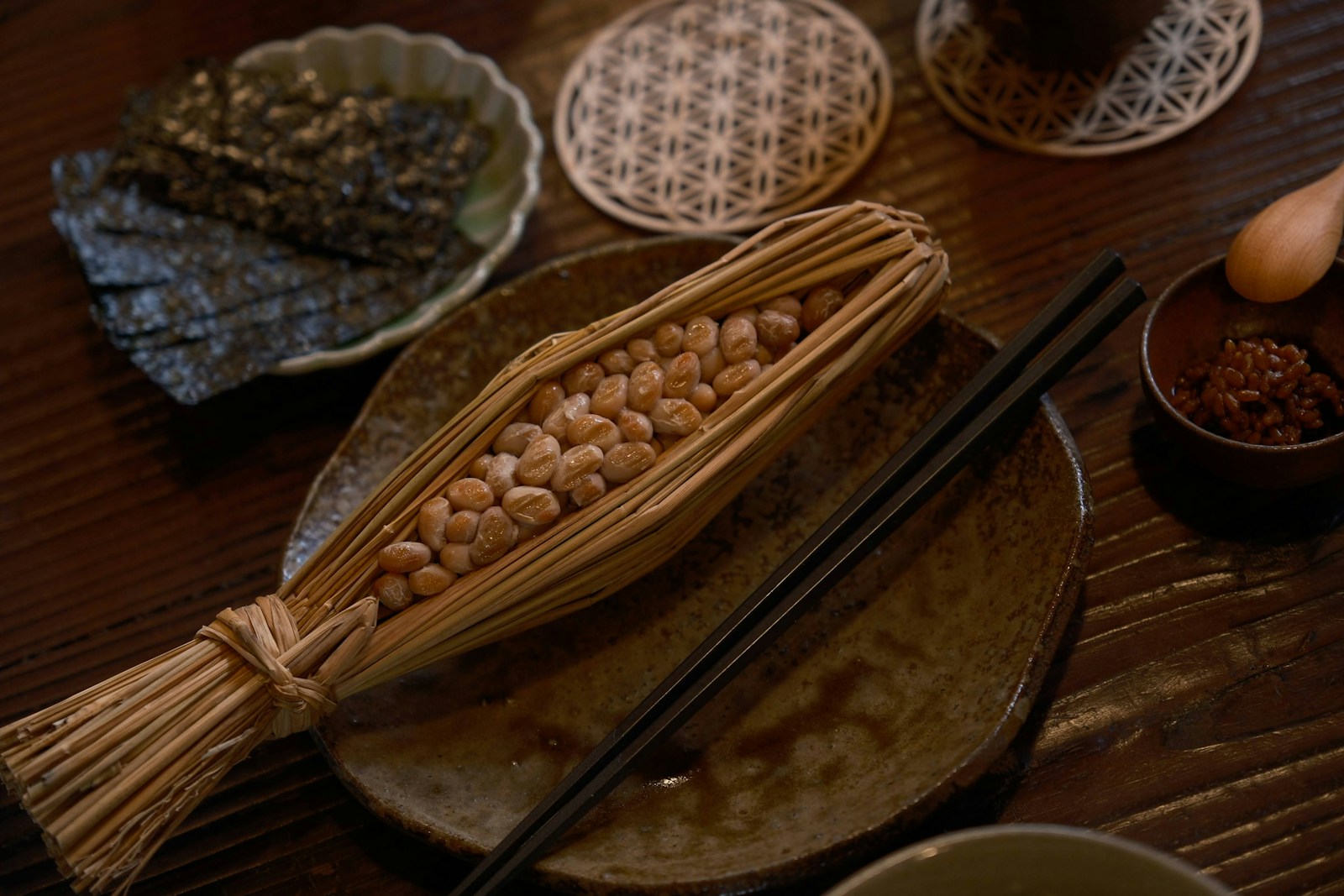 a wooden table topped with plates and bowls filled with food